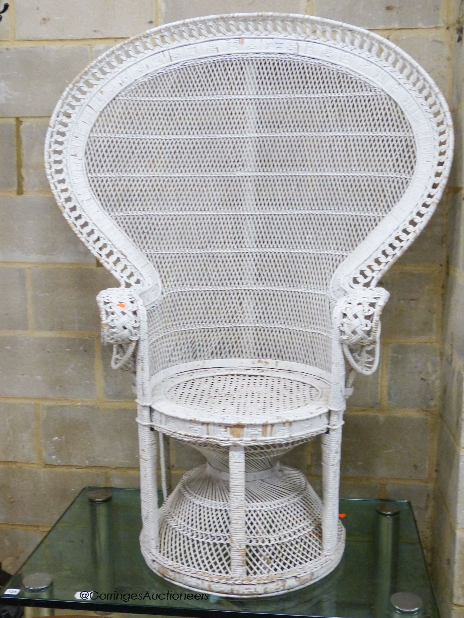 A white painted wickerwork peacock armchair, width 110cm, height 146cm